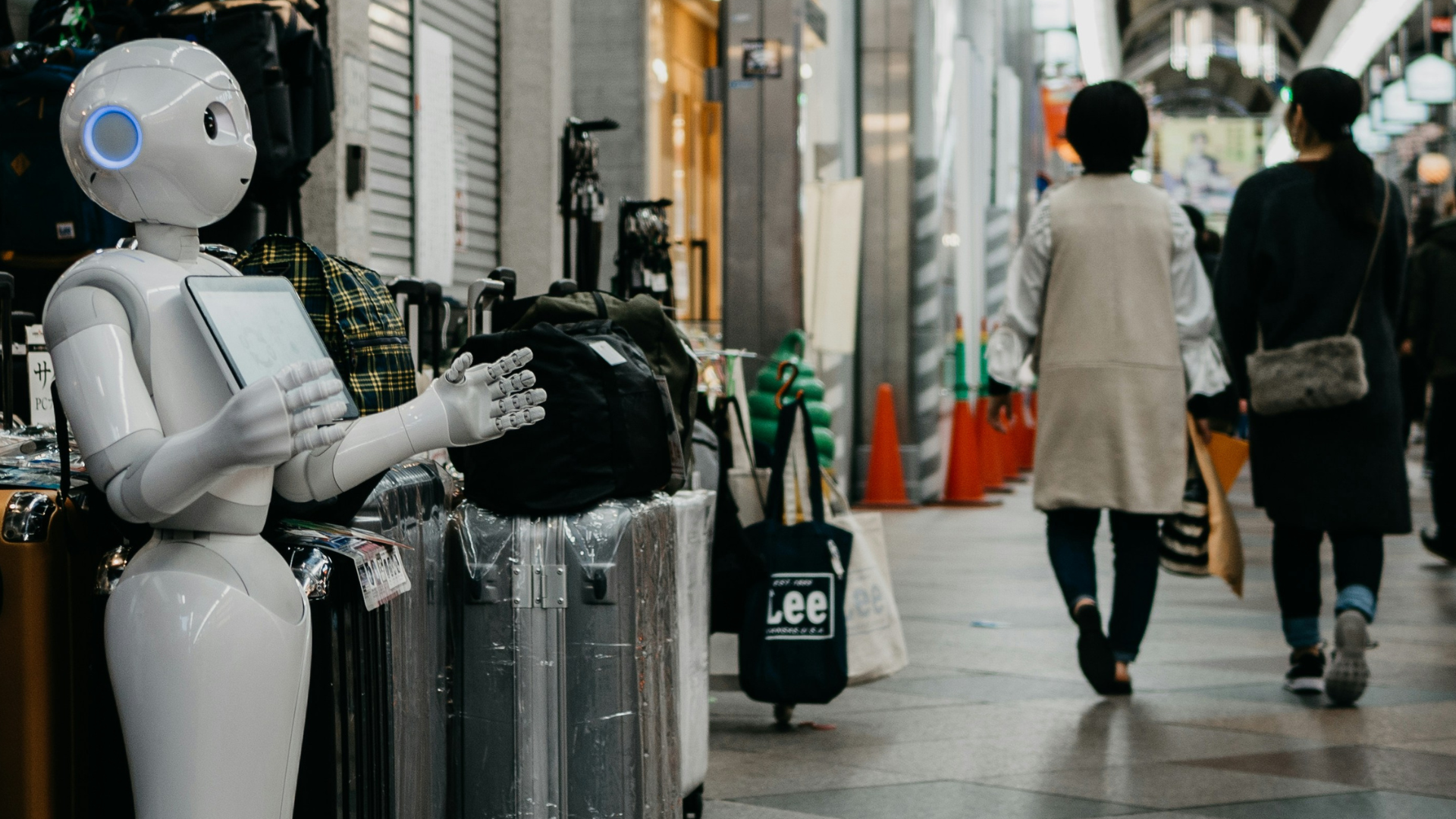 A robot holds its hands open to pedestrians